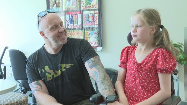 Jeff, with his daughter Irelynn. Irelynn is working to use a brain computer interface, technology that allows her to control objects by thought. A young girl with her dad