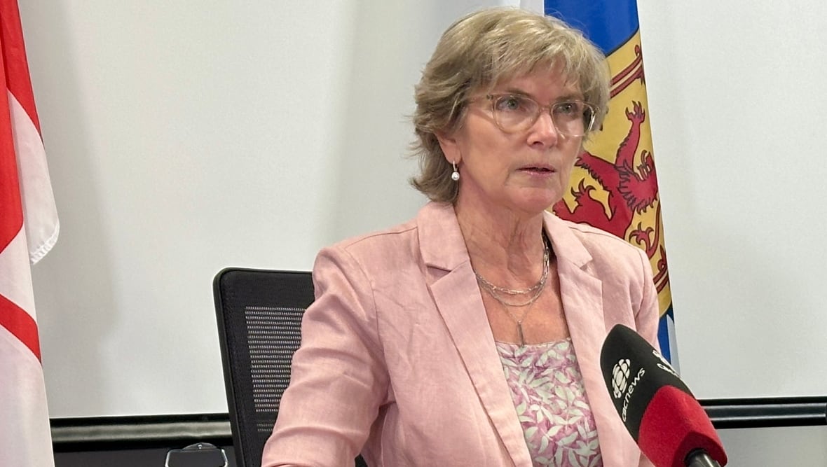 A woman speaks into a microphone.