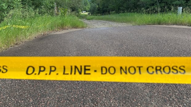 Yellow police tape that says "O.P.P Line. Do not cross"