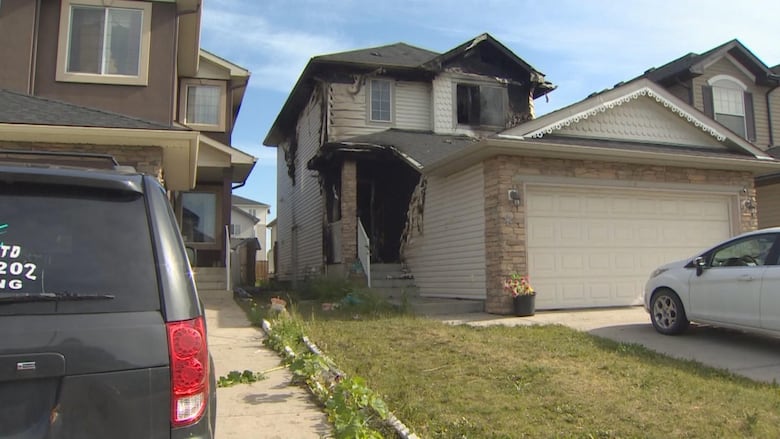 a fire damaged house is pictured