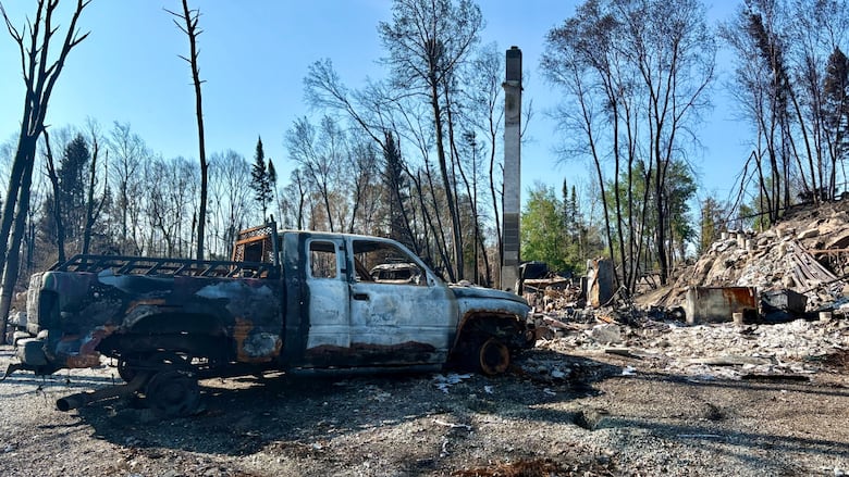A photo of a destroyed truck and building