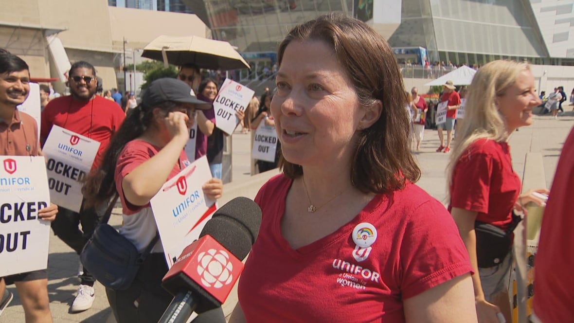 woman, wearing red shirt, speaking to the mic.