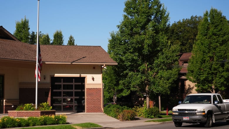 A building with a large garage with an American flag at half-mast.