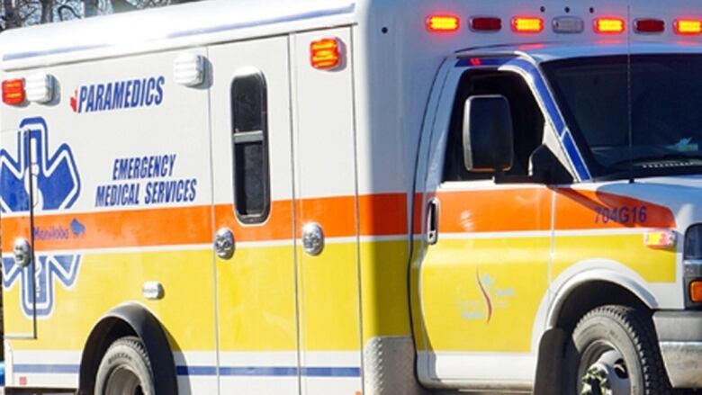 The broadside  of a white, yellowish  and orangish  coloured ambulance is seen successful  this representation   