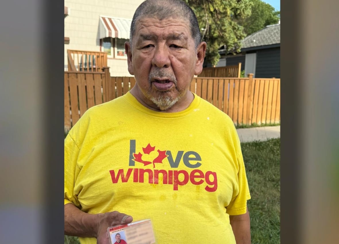 A man holds an identification card.