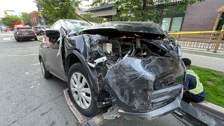 Photo of a black car with damage to its bumper