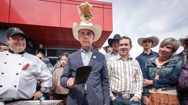 Splat: Prime Minister Carney struggles to flip perfect pancake at Calgary Stampede
