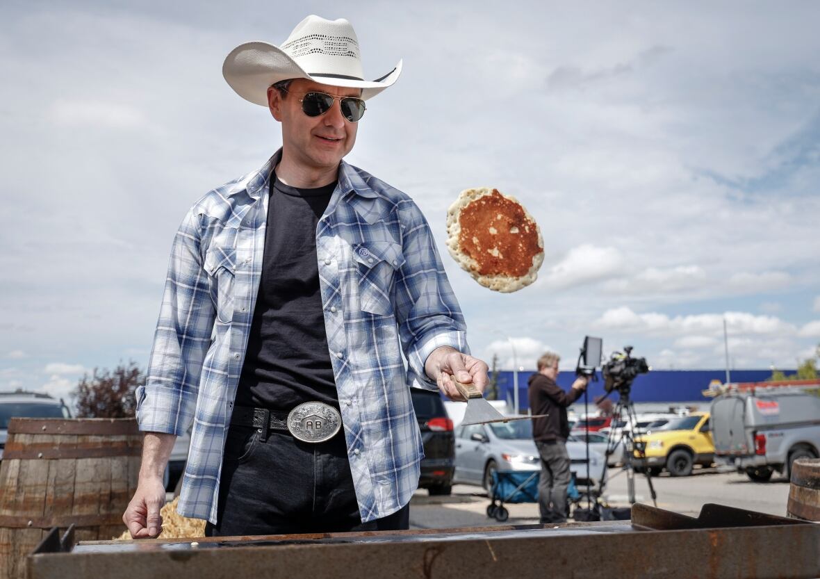 Conservative Leader Pierre Poilievre flips pancakes as he attends a Stampede breakfast in Calgary, Alta., Saturday, July 5, 2025.