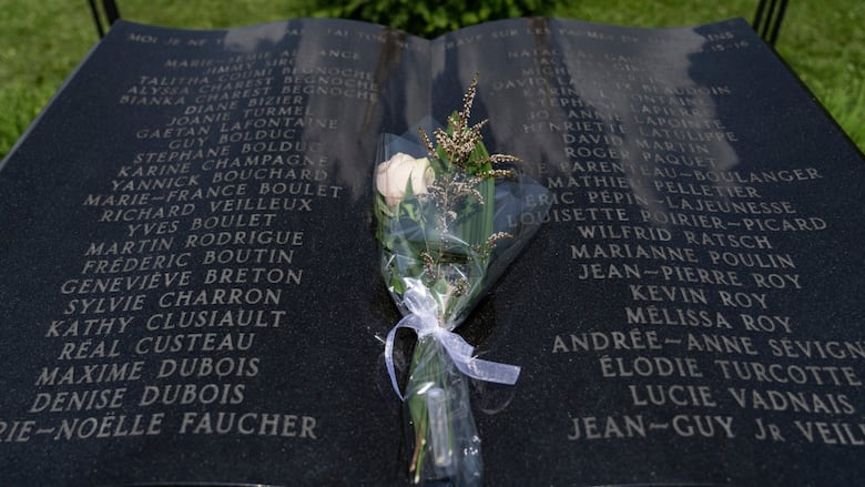 A white rose is seen on a plaque listing the names of 47 victims of the 2013 rail disaster in Lac-Mégantic, Que.