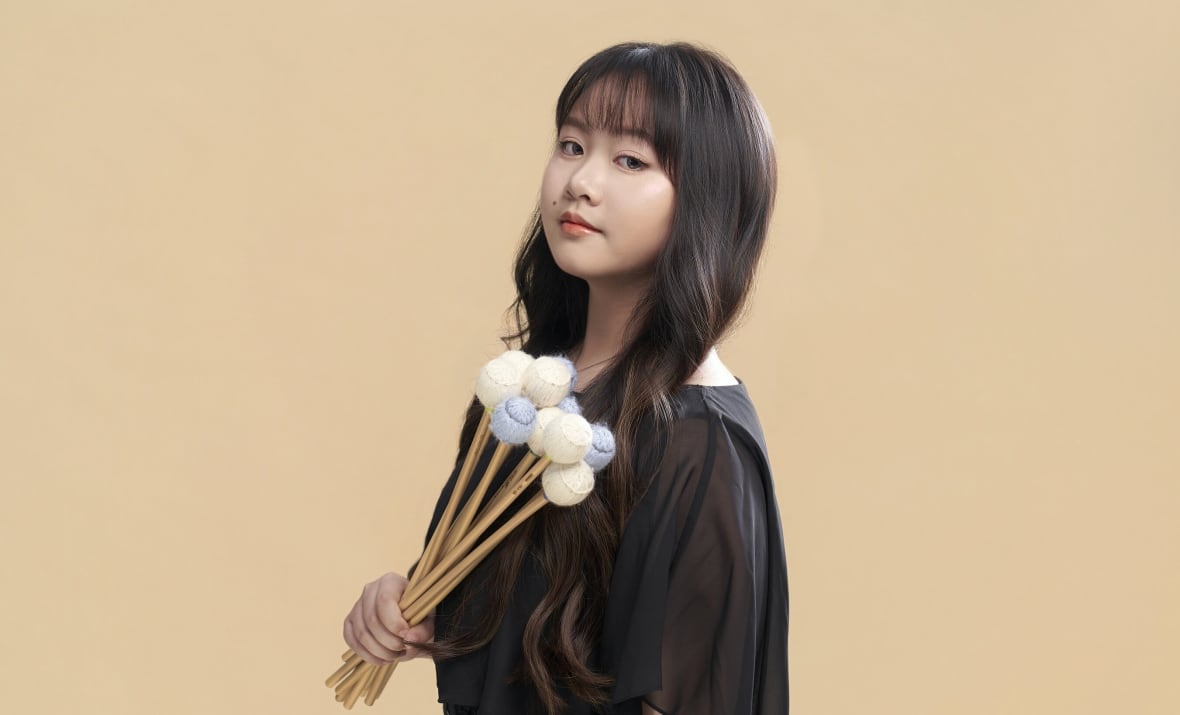 Percussionist Valerie Lin holds a set of mallets.