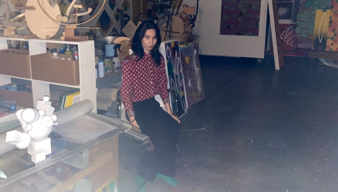 Composer Kai Kubota-Enright is pictured in an artist's studio.