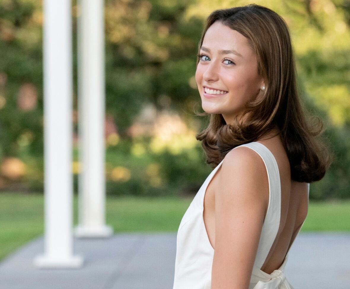 A person smiles while posing for a photograph.