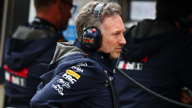 A man wearing an over-the-ear headset is shown from a side profile.