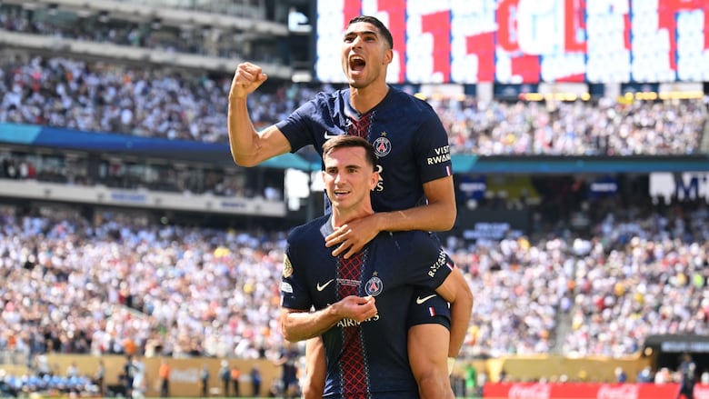 Two players celebrate a goal during a game.