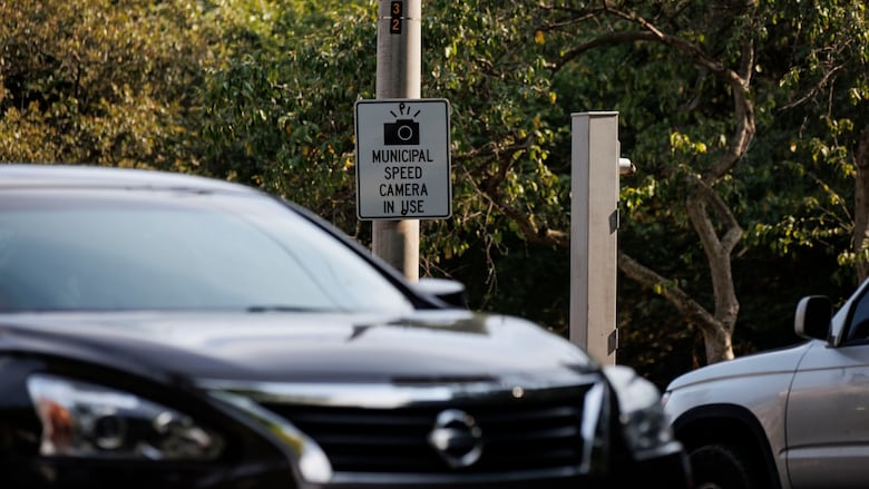 Rush hour motorists drive past a stanchion that once held a speed camera on Parkside Dr., which runs along the eastern edge of Toronto’s High Park, on July 9, 2025.