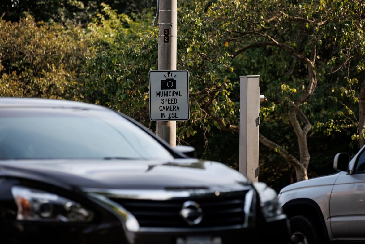 Rush hour motorists drive past a stanchion that once held a speed camera on Parkside Dr., which runs along the eastern edge of Toronto’s High Park, on July 9, 2025.