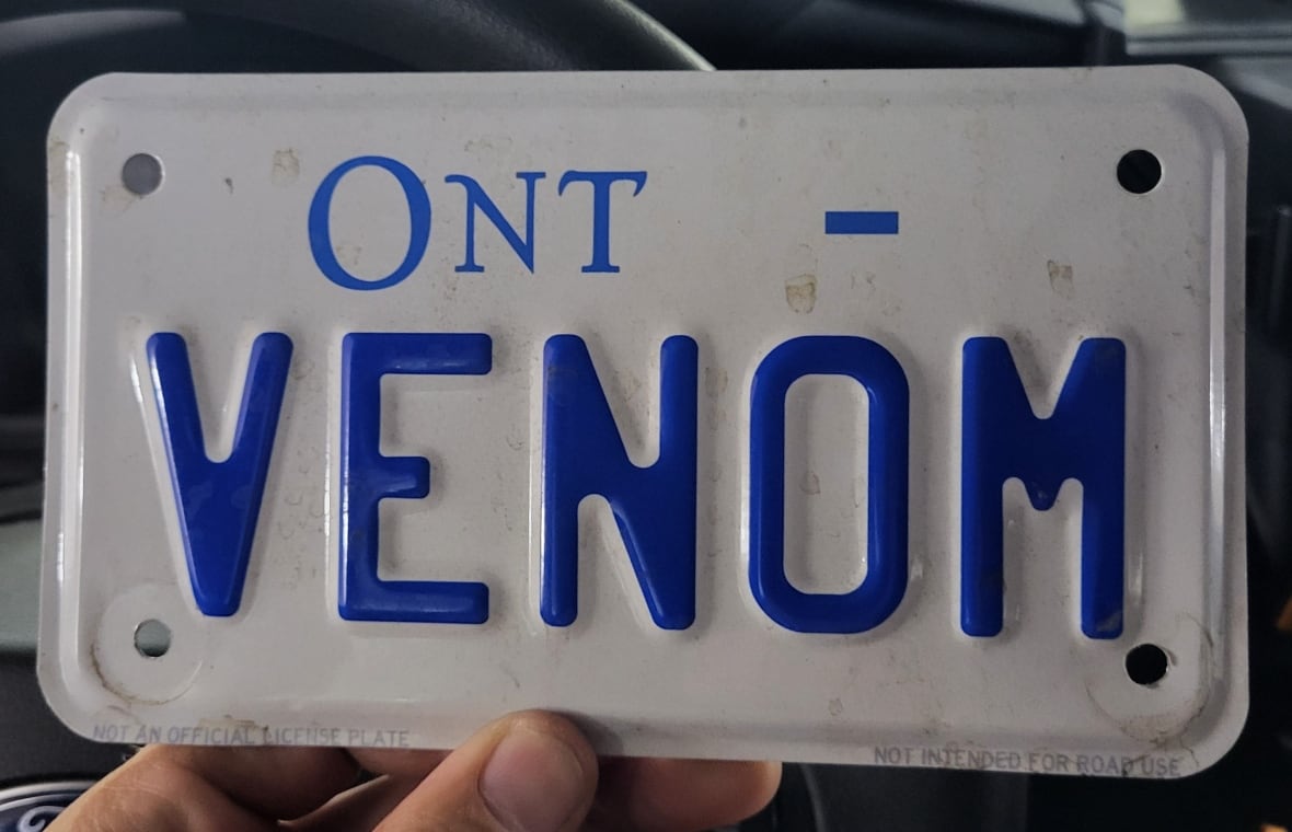 A fake licence plate says "VENOM."