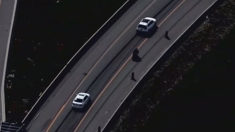 Motorcycle seen trying overcome a car while driving at high speeds.