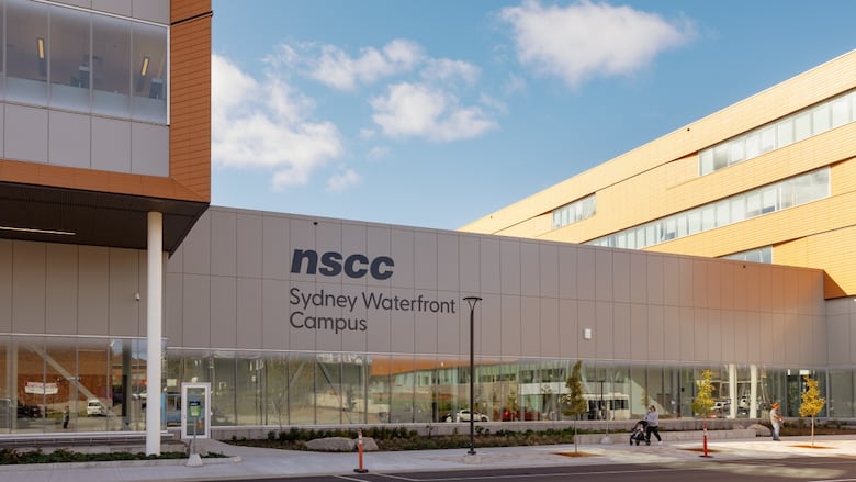 An institutional building is seen with a sign that says NSCC Sydney Waterfront Campus.