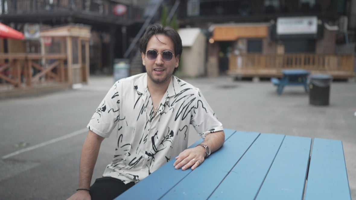 A man in white with sunglasses.