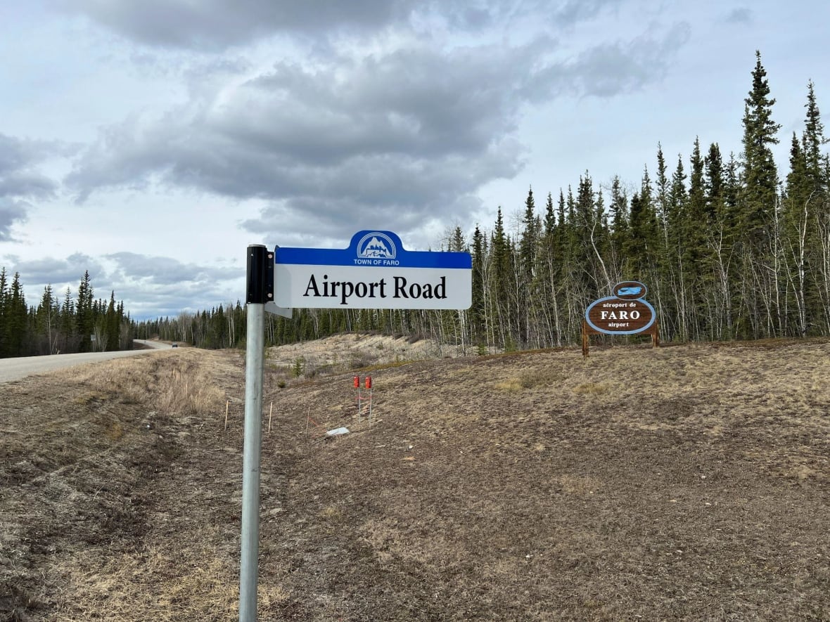 A road sign along a remote road on a cloudy day. 