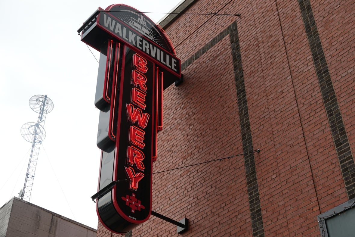 A neon sign reads "Walkerville Brewery" hung on big brick wall.
