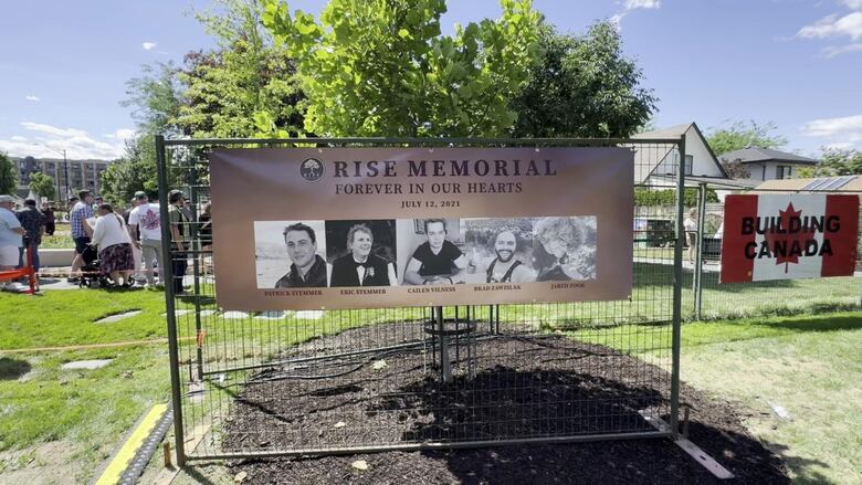 A banner bearing the names and photos of Patrick Stemmer, Eric Stemmer, Cailen Vilness, Brad Zawislak and Jared Zook is displayed at the newly unveiled Rise Memorial Gardens in Kelowna, commemorating the fourth anniversary of the 2021 crane collapse that claimed their lives.