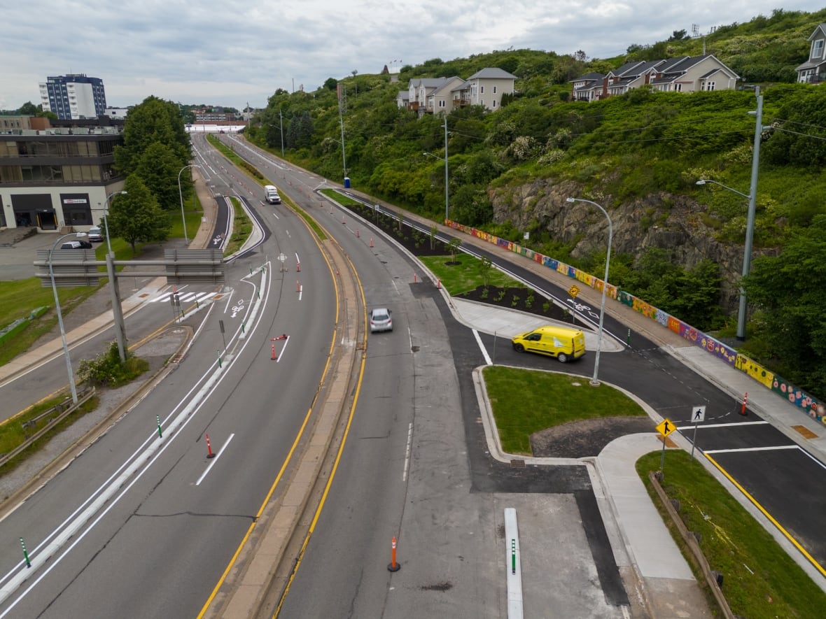 Aerial shot of viaduct with some cars driving taken with a drone. Cloudy skies.