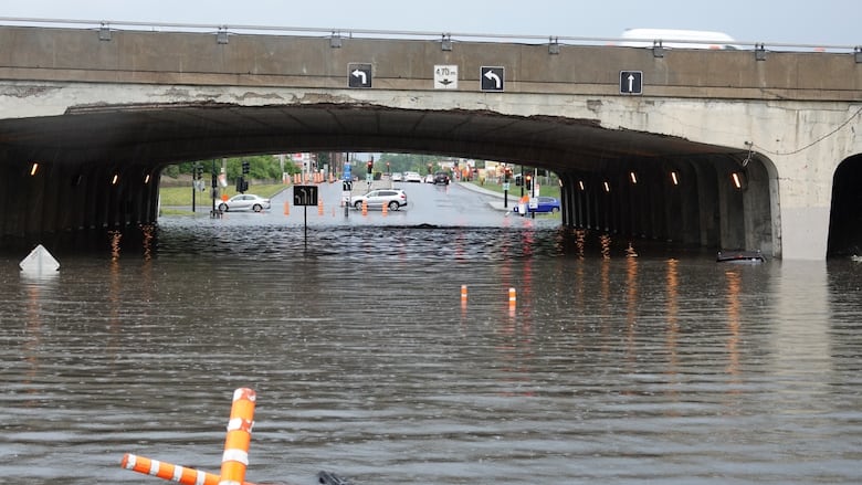 Water fills an underpass, leaving lone  the apical  of a thoroughfare  motion   and the precise  apical  of a conveyance  visible.