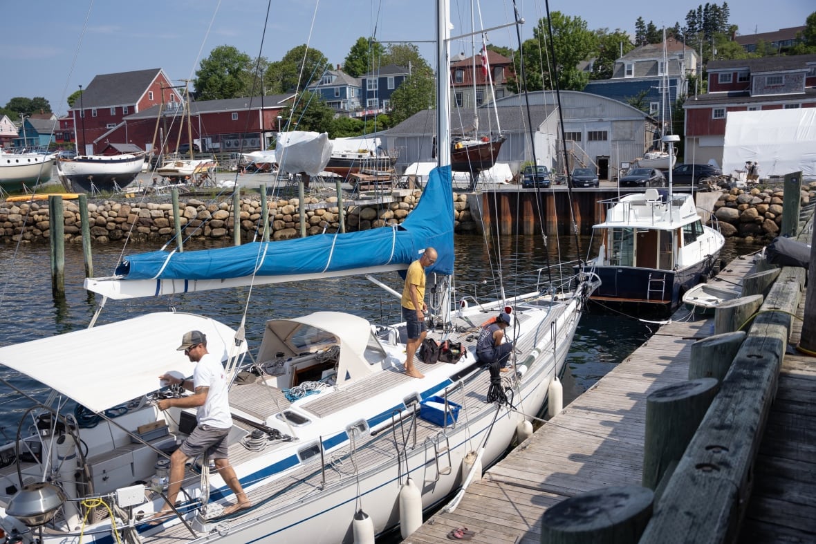 People work on a bdocked boat.