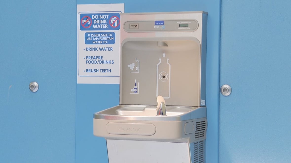 A fountain for drinking or refilling a water bottle, with a sign next to it saying the water isn't safe for consumption.