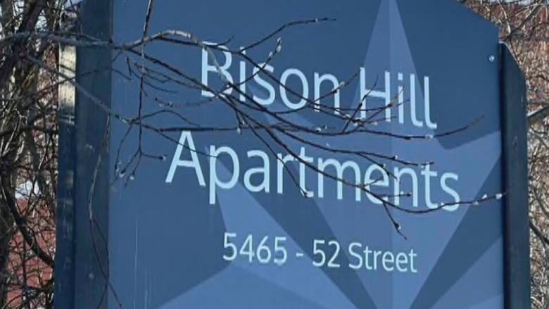 a sign that says Bison Hill Apartments