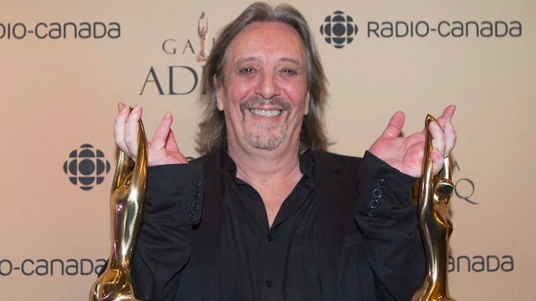 Serge Fiori holds up   his Felix grant  for champion  big  contempory medium  astatine  the gala Adisq awards ceremonial  successful  Montreal.