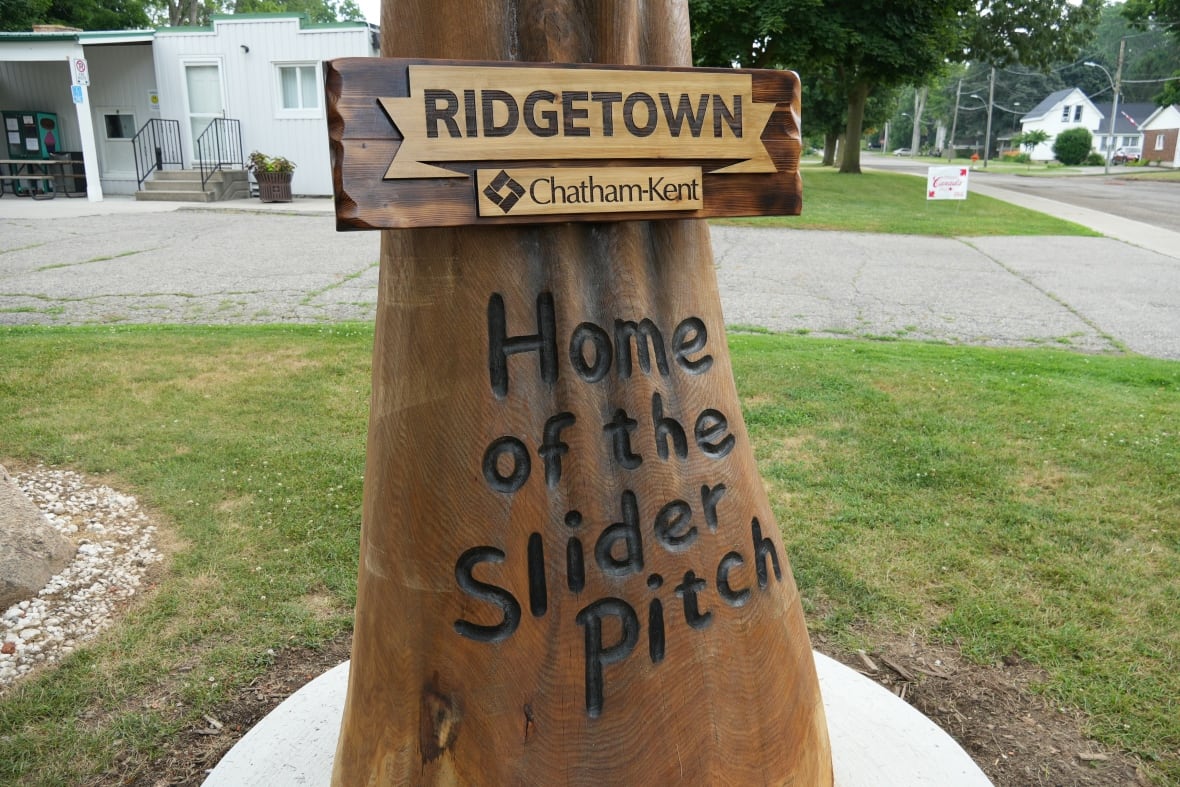 Wood carving highlighting Ridgetown's connection to the baseball pitch known as the slider.