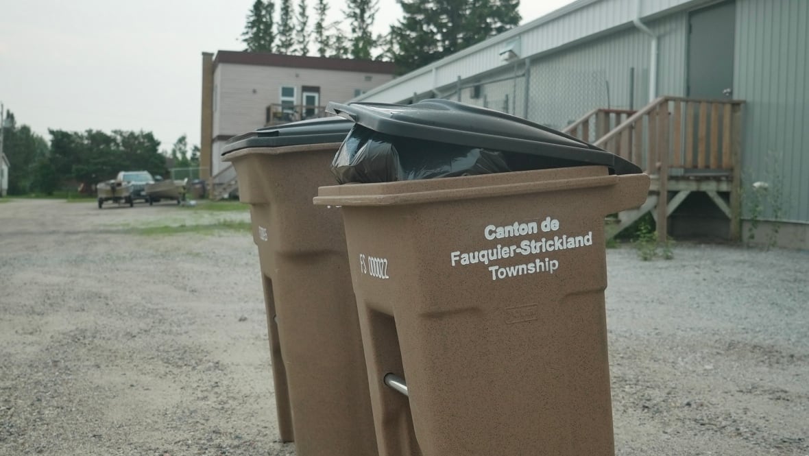 Two brown garbage bins with the words 'Canton de Fauquier-Strickland Township' on the side