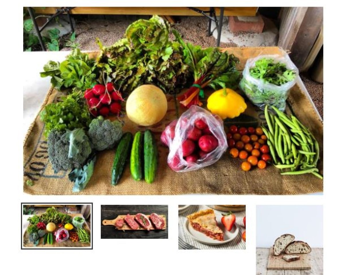 Vegetables laid out on a bulap tarp, including beet greens, radishes, squash, cucumbers, broccoli, red potatoes, tomatoes, green beens and lettuce