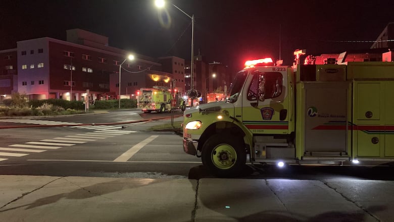 Ambulance parked at intersection at night