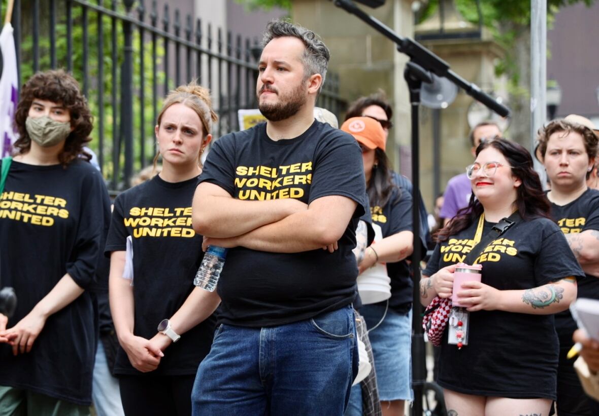 A group of people wearing shirts that read "shelter workers united."