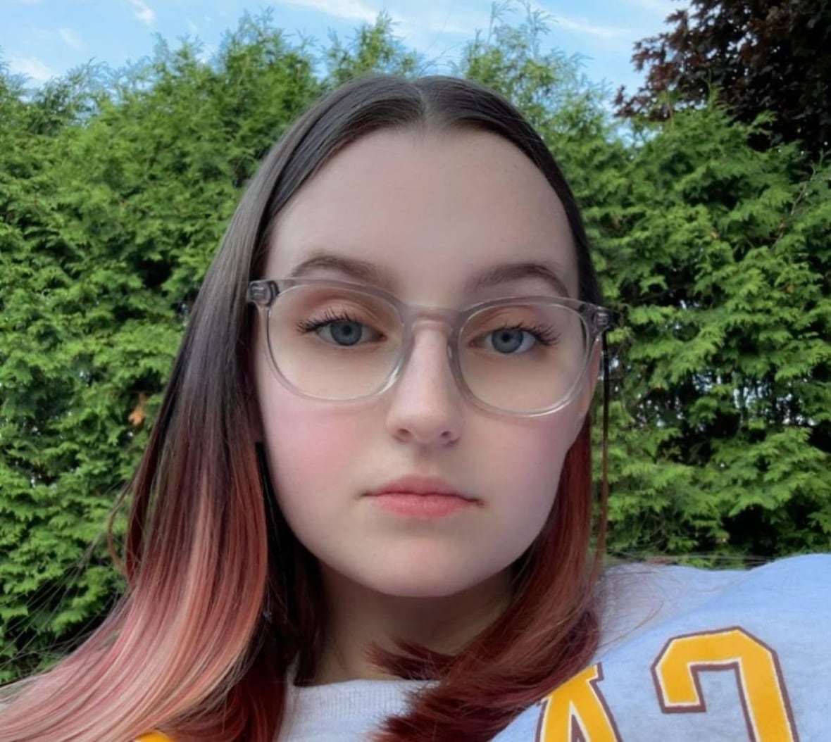 A young woman stares at the camera