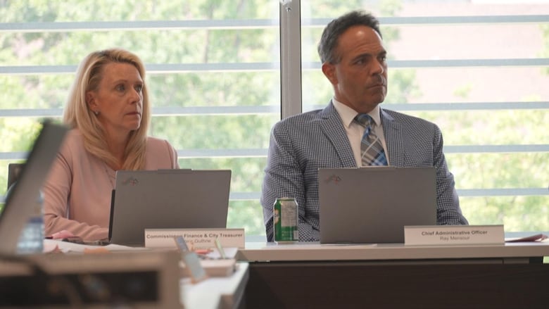 City treasurer Janice Guthrie and Chief Administrative Officer Ray Mansour listen to a presentation during a council meeting at city hall.