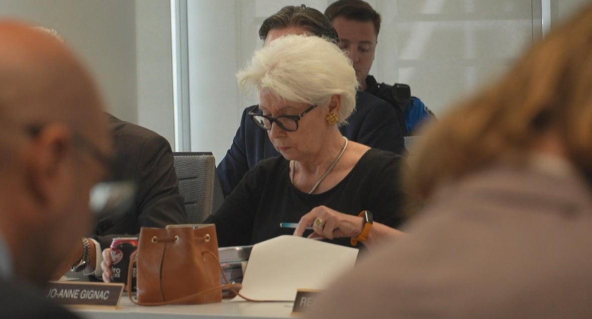 Councillor Jo-Anne Gignac reviews documents during a public council meeting at city hall.