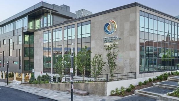 A large commercial building is seen from the street.