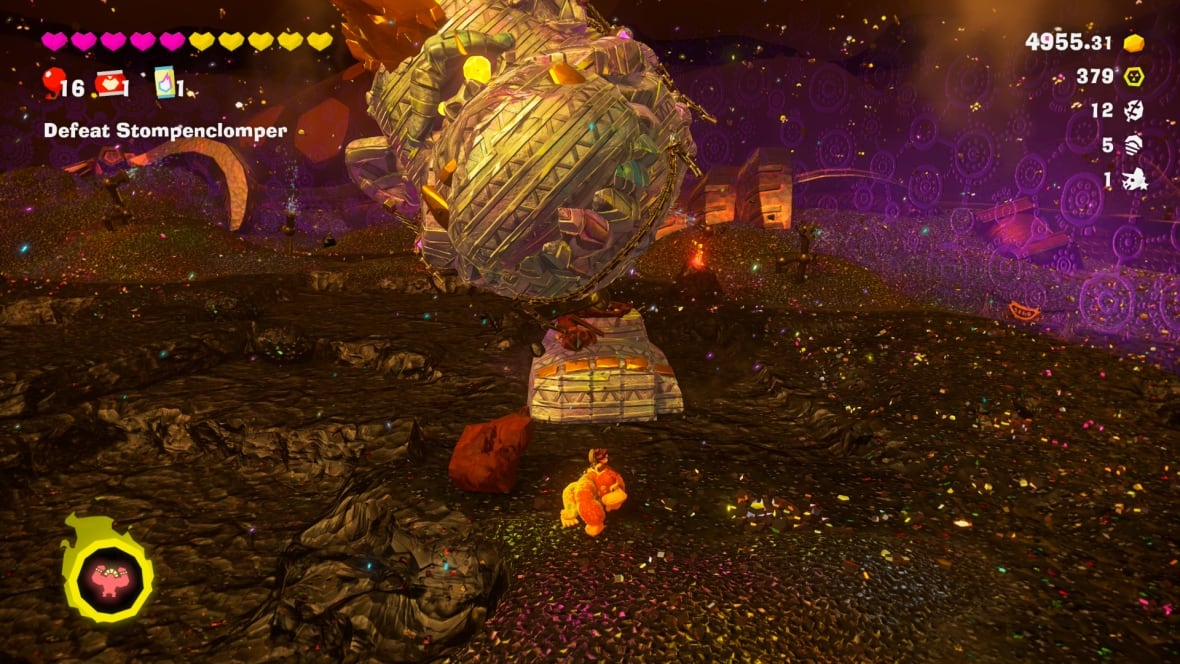 video game screenshot of donkey kong fighting a giant stone monkey's head
