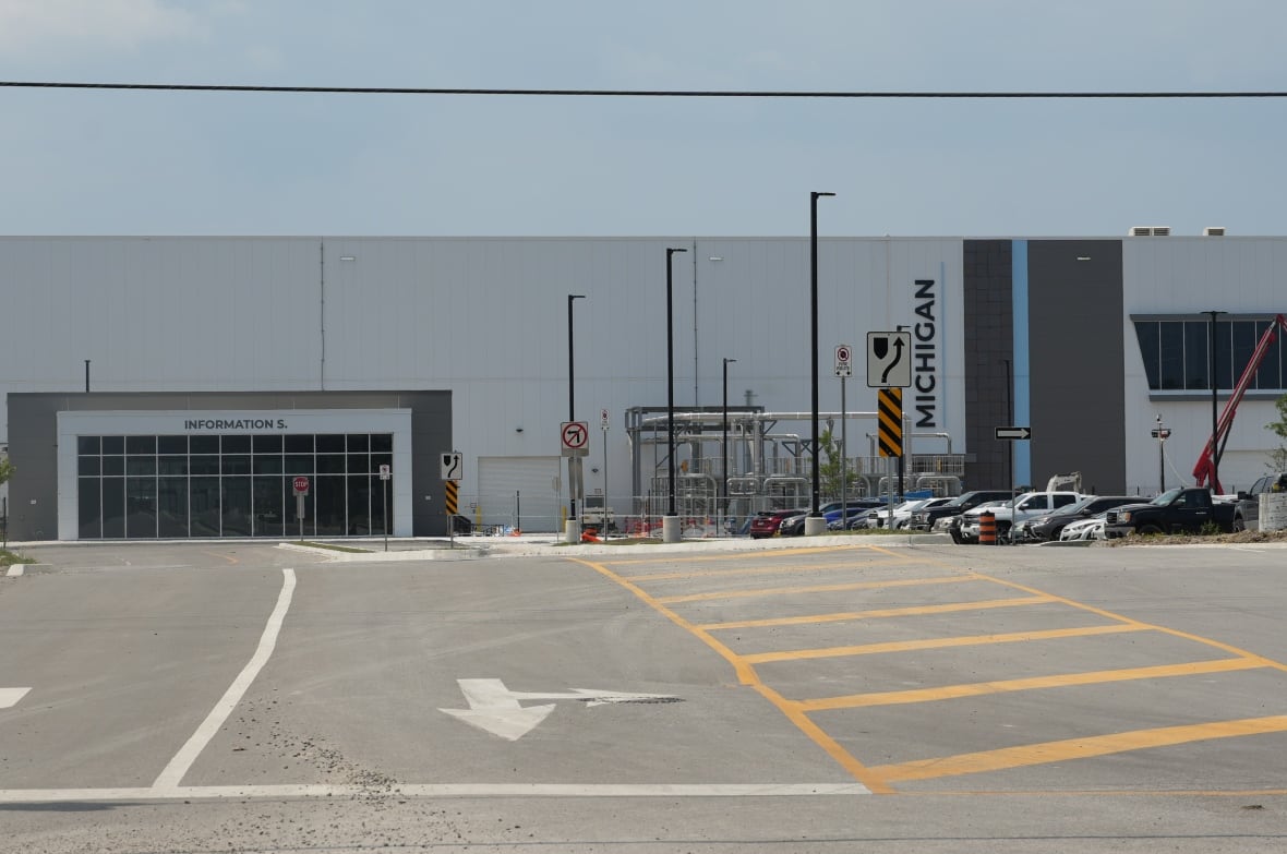 An industrial building with cars parked out front
