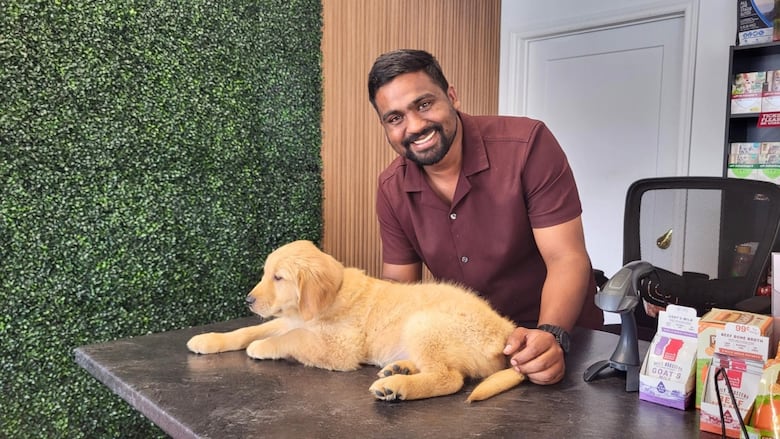 A antheral   smiles. A puppy canine  is sitting connected  the antagonistic  successful  front. 