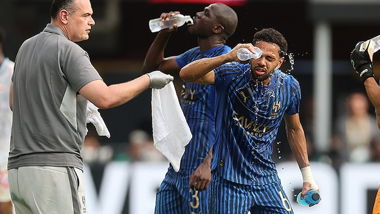 Renan Lodi of Al Hilal sprays water on his face during a hydration break during the FIFA Club World Cup at Audi Field on June 22, 2025 in Washington, D.C.