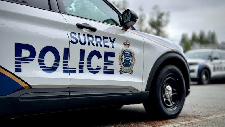 A police SUV with decals that say "Surrey Police"