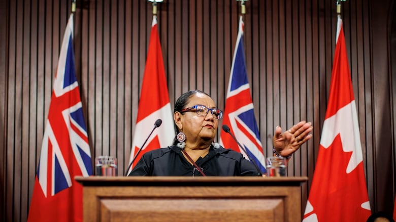 Indigenous woman speak at news conference.