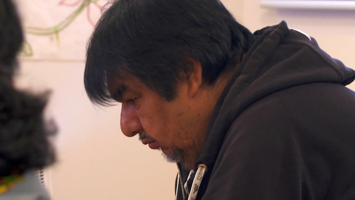 A man in a black sweater. 