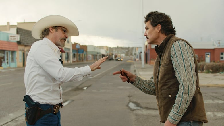 A man in a cowboy hat argues with a man in a vest.